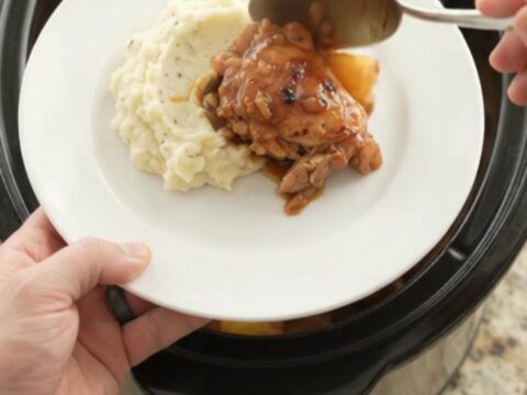 Slow cooker pineapple bourbon glazed chicken thighs, caramelized and glossy