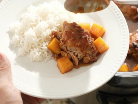 Slow cooker mango hickory BBQ chicken thighs with sauce and mango cubes
