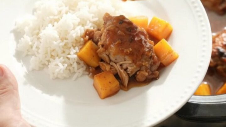 Slow cooker mango hickory BBQ chicken thighs with sauce and mango cubes