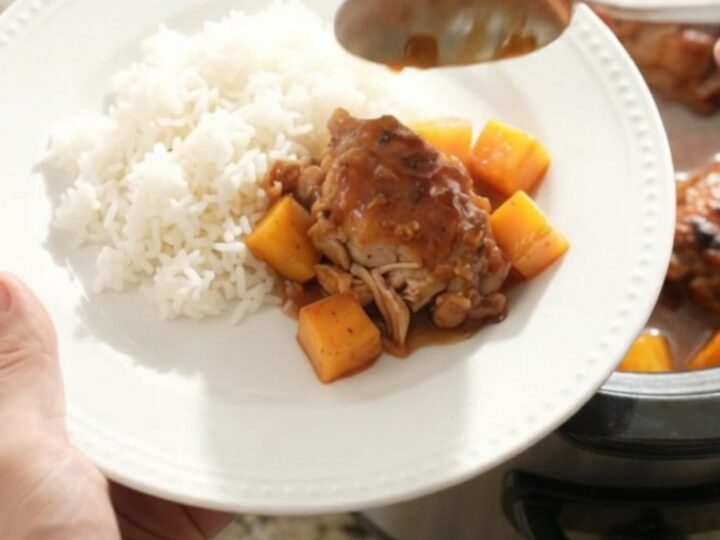 Slow cooker mango hickory BBQ chicken thighs with sauce and mango cubes