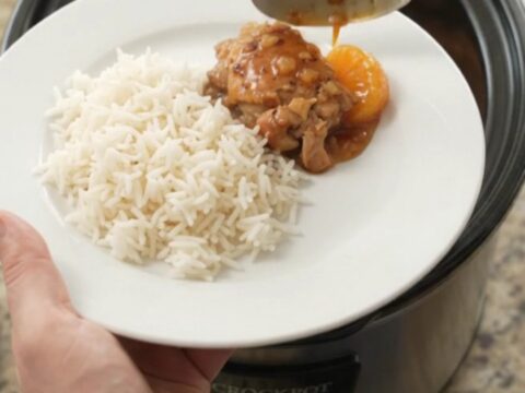Mandarin honey soy chicken thighs in a slow cooker, glistening with sticky sauce