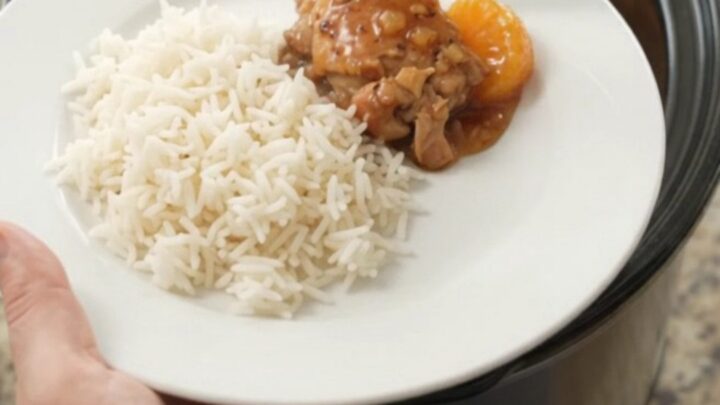 Mandarin honey soy chicken thighs in a slow cooker, glistening with sticky sauce