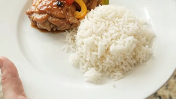 Slow cooker filled with teriyaki chicken thighs and bell peppers