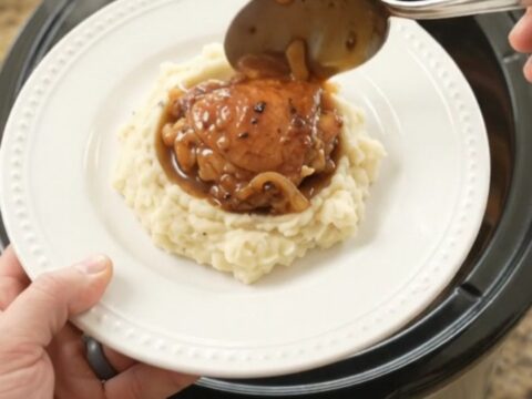 Caramelized bourbon glazed chicken thighs with Vidalia onions in a slow cooker