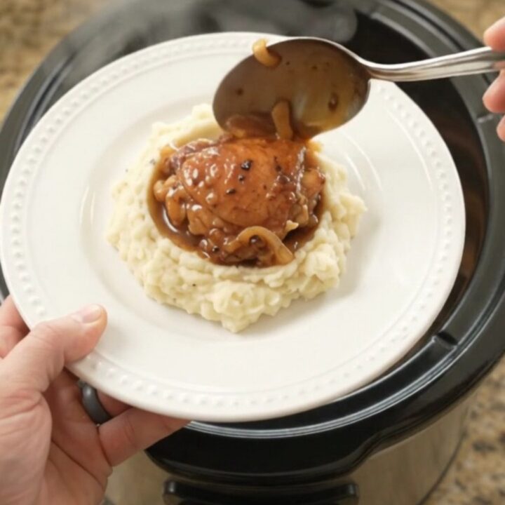 Caramelized bourbon glazed chicken thighs with Vidalia onions in a slow cooker