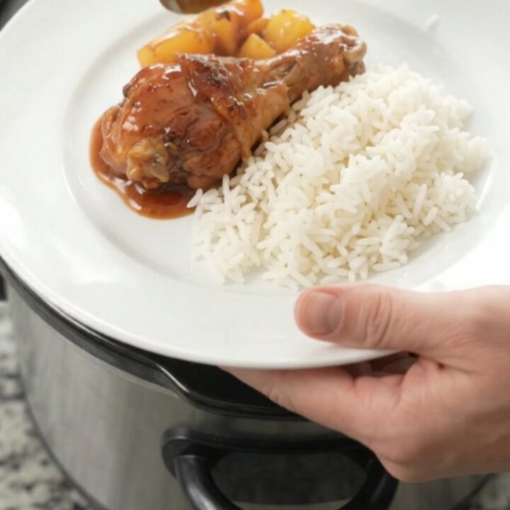 Glazed chicken drumsticks and pineapple in a slow cooker