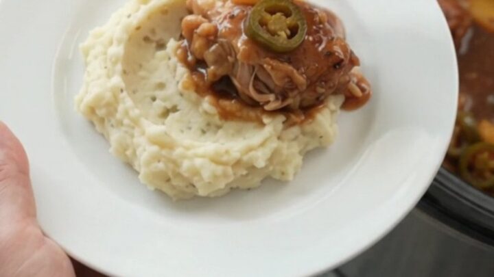 Slow cooker bourbon glazed chicken thighs with pineapple and jalapeños in a glossy sauce