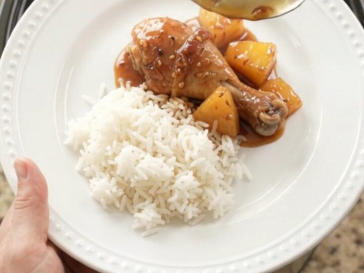 Glazed chicken drumsticks with pineapple in a slow cooker, topped with sesame seeds