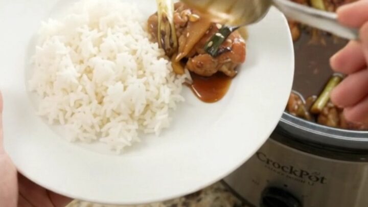 Slow cooker teriyaki chicken thighs with ginger and scallions in a glossy glaze