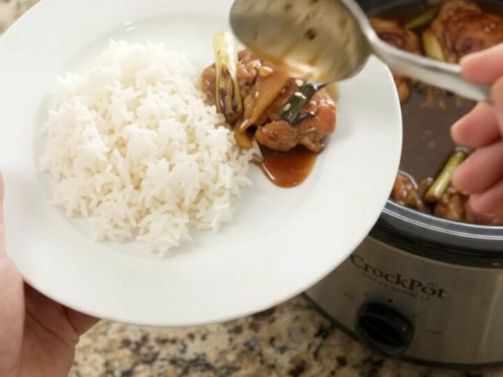 Slow cooker teriyaki chicken thighs with ginger and scallions in a glossy glaze