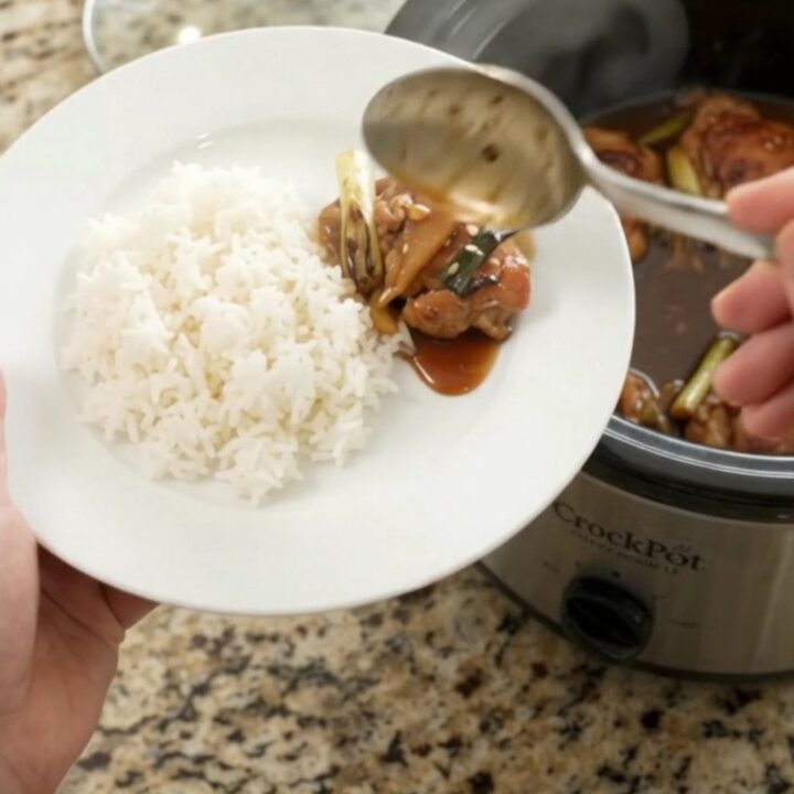 Slow cooker teriyaki chicken thighs with ginger and scallions in a glossy glaze