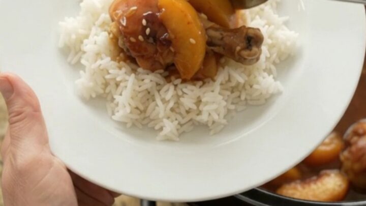 Slow cooker peach teriyaki chicken drumsticks with glossy sauce and sesame seeds