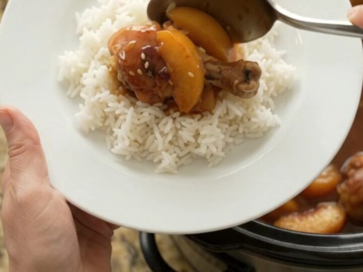 Slow cooker peach teriyaki chicken drumsticks with glossy sauce and sesame seeds