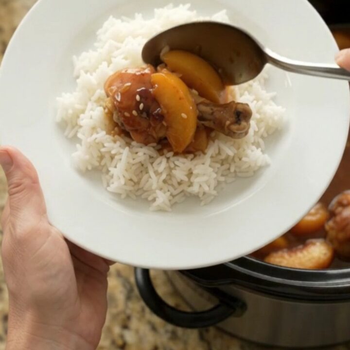 Slow cooker peach teriyaki chicken drumsticks with glossy sauce and sesame seeds