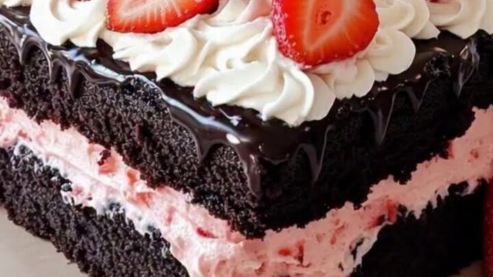 Layered chocolate and strawberry ding dong sheet cake on a wooden board.
