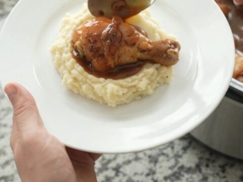Slow cooker chicken drumsticks glazed with bourbon molasses sauce and mandarin oranges