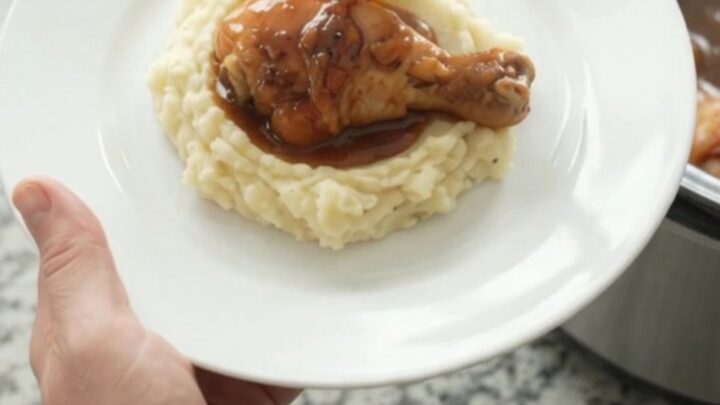 Slow cooker chicken drumsticks glazed with bourbon molasses sauce and mandarin oranges