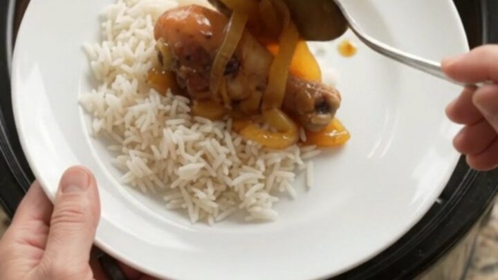 Glazed chicken drumsticks in a slow cooker with apricot onion sauce