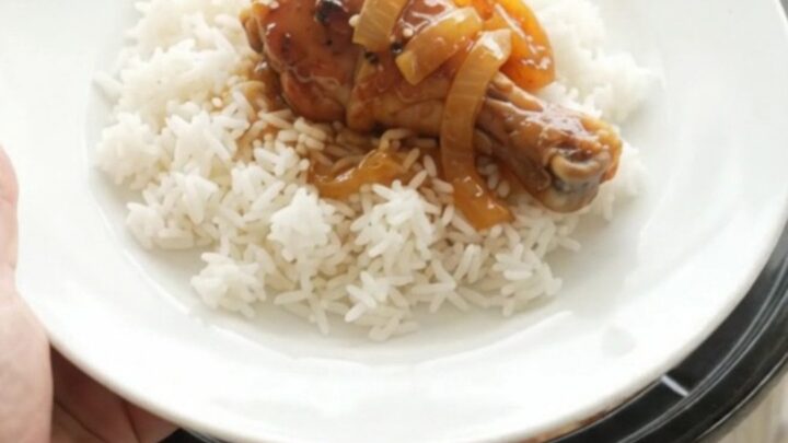 Glazed chicken drumsticks in a slow cooker with apricot teriyaki sauce and sesame seeds