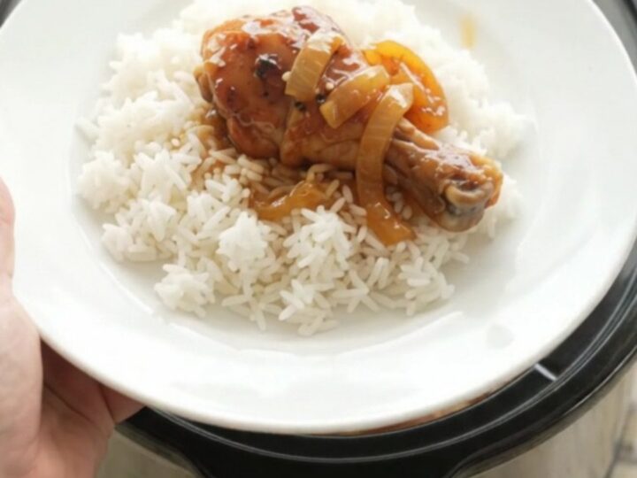 Glazed chicken drumsticks in a slow cooker with apricot teriyaki sauce and sesame seeds