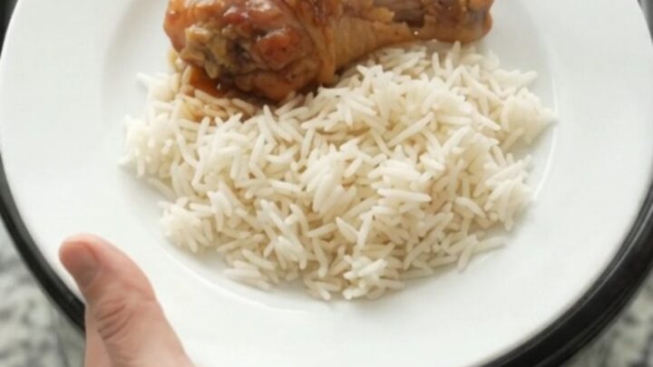 Glazed chicken drumsticks in a slow cooker with garlic and scallions, sticky honey soy sauce bubbling