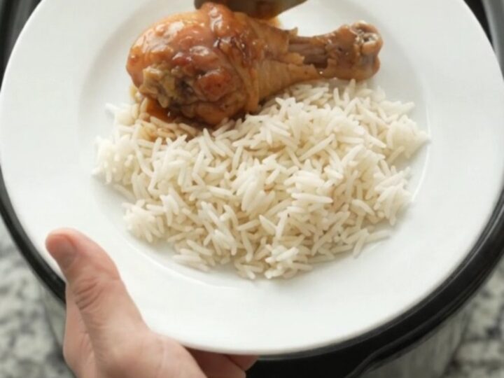 Glazed chicken drumsticks in a slow cooker with garlic and scallions, sticky honey soy sauce bubbling