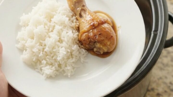 Slow-cooker teriyaki chicken drumsticks with whole garlic cloves and scallions in a glossy sauce.