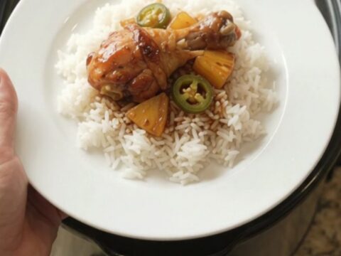 Glazed chicken drumsticks with pineapple and jalapeños in a slow cooker