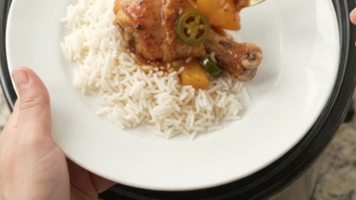 Glazed chicken drumsticks with pineapple and jalapeño in a slow cooker, sticky sauce bubbling