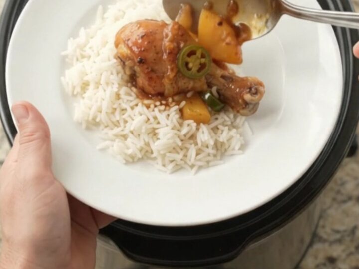 Glazed chicken drumsticks with pineapple and jalapeño in a slow cooker, sticky sauce bubbling