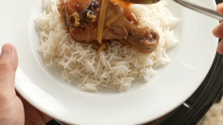 Glazed chicken drumsticks in a slow cooker with ginger and scallions in a sticky sauce