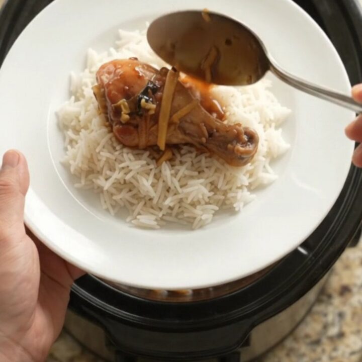 Glazed chicken drumsticks in a slow cooker with ginger and scallions in a sticky sauce