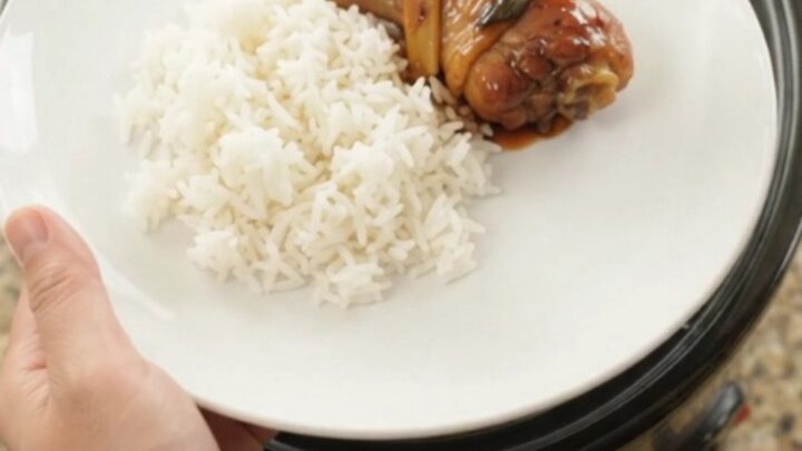Slow-cooker chicken drumsticks glazed in hickory BBQ sauce with ginger and scallions, served on a white plate