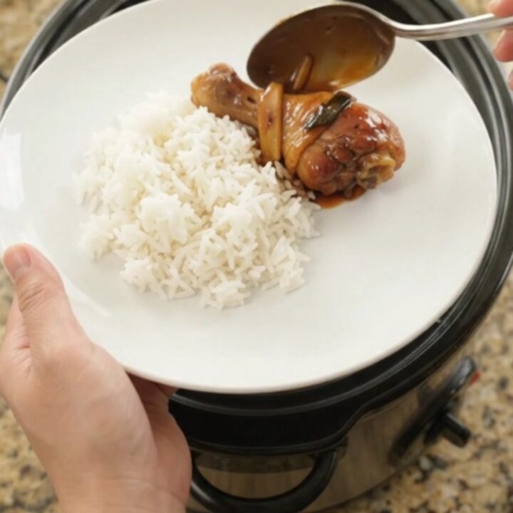 Slow-cooker chicken drumsticks glazed in hickory BBQ sauce with ginger and scallions, served on a white plate