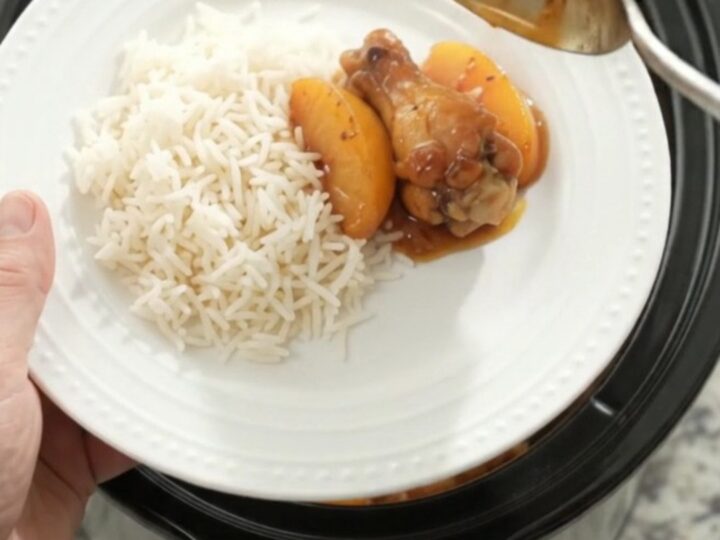 Sticky peach honey soy chicken wings in a slow cooker, glistening with sauce