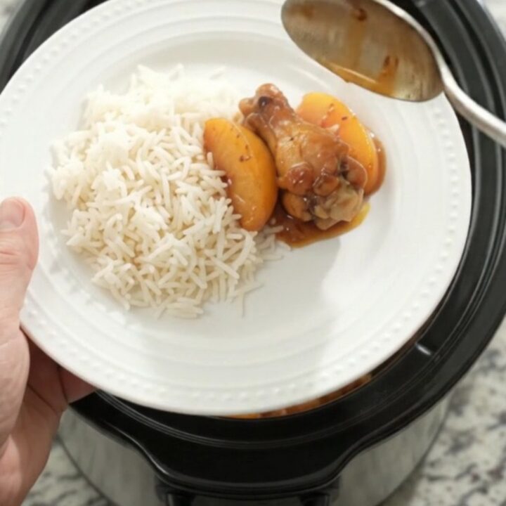 Sticky peach honey soy chicken wings in a slow cooker, glistening with sauce
