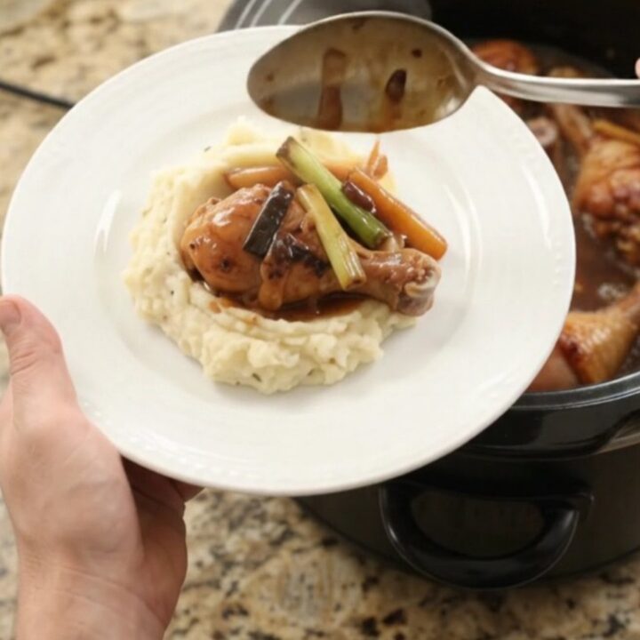 Glazed chicken drumsticks in a slow cooker with ginger and scallions