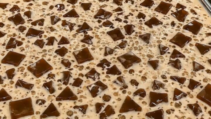 A close-up view of creamy Milo gulaman featuring firm chocolate jelly cubes and tapioca pearls.