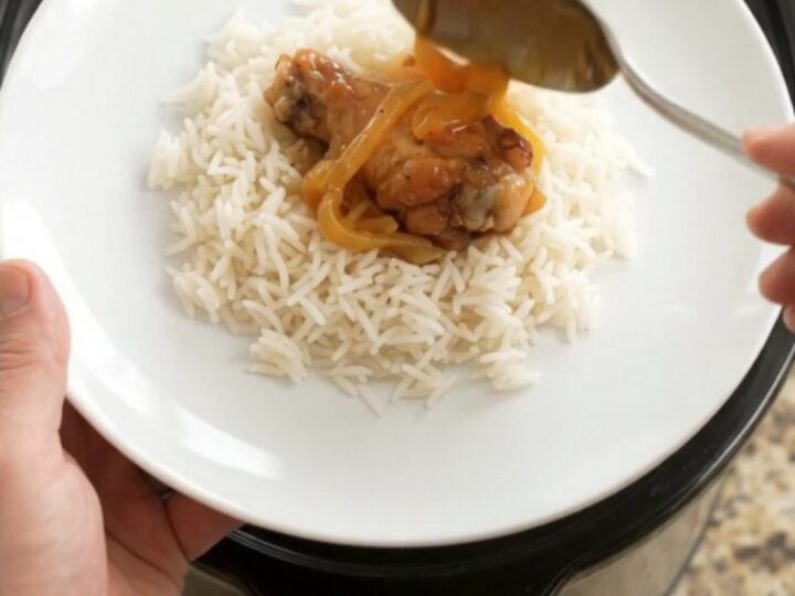 Sticky apricot honey soy chicken wings in a slow cooker with glossy glaze and steam rising
