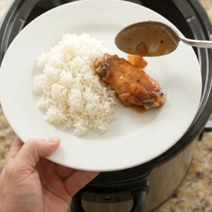 Sticky apricot hickory BBQ chicken wings in a slow cooker, glistening with dark sauce