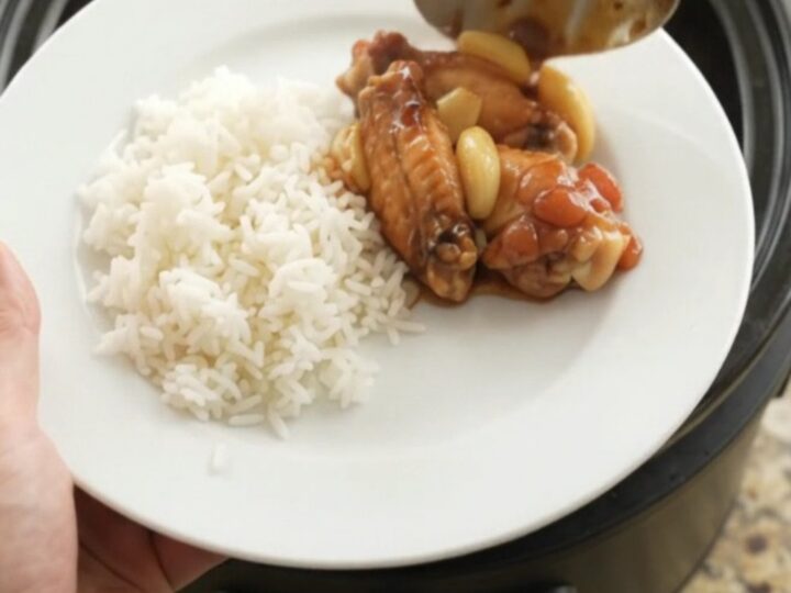 Slow cooker chicken wings in glossy hickory BBQ sauce with garlic and scallions