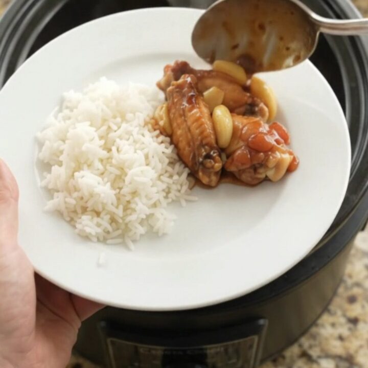 Slow cooker chicken wings in glossy hickory BBQ sauce with garlic and scallions