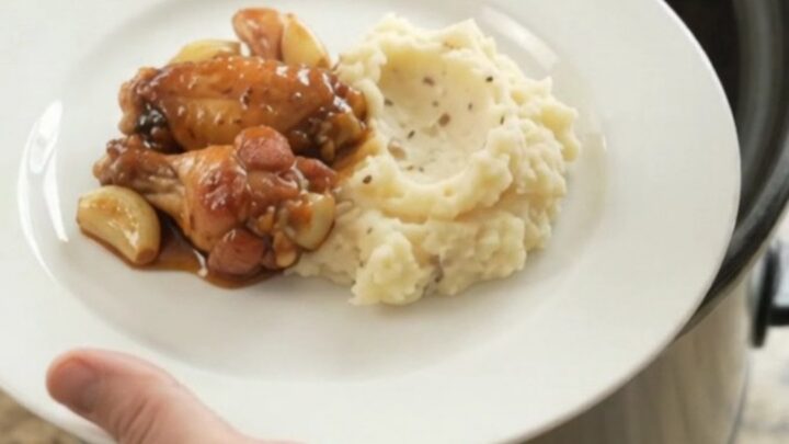 Sticky bourbon glazed chicken wings in a slow cooker with garlic and scallions