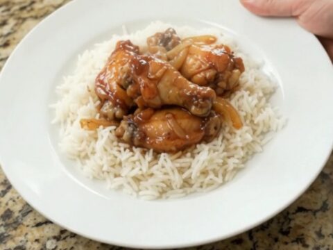 Sticky honey soy chicken wings with caramelized onions in a slow cooker