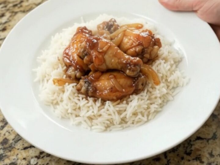 Sticky honey soy chicken wings with caramelized onions in a slow cooker