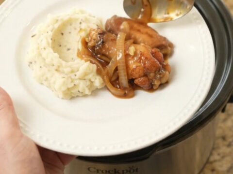 Sticky bourbon-glazed chicken wings with caramelized Vidalia onions in a slow cooker