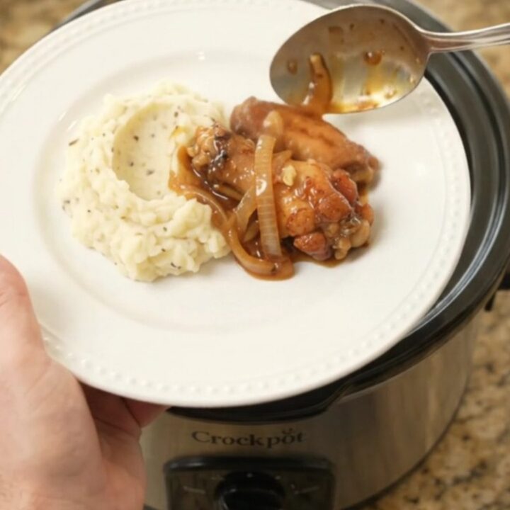 Sticky bourbon-glazed chicken wings with caramelized Vidalia onions in a slow cooker