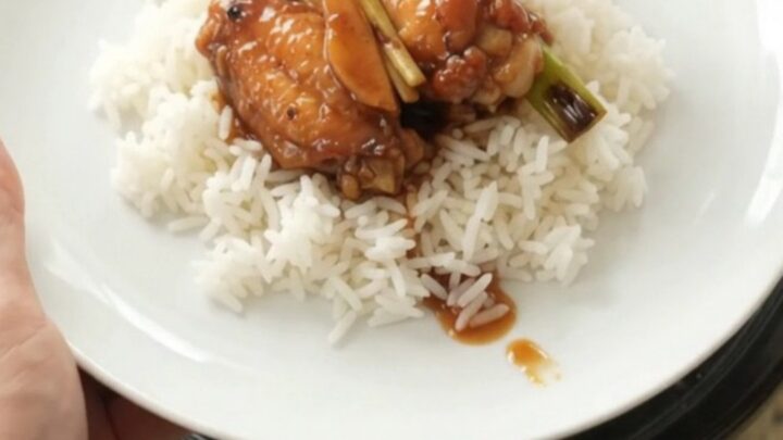 Slow cooker hickory BBQ chicken wings with ginger and scallions in a black crockpot