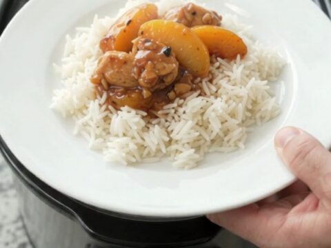 Slow cooker chicken and peaches in a glossy honey-soy sauce, served over rice