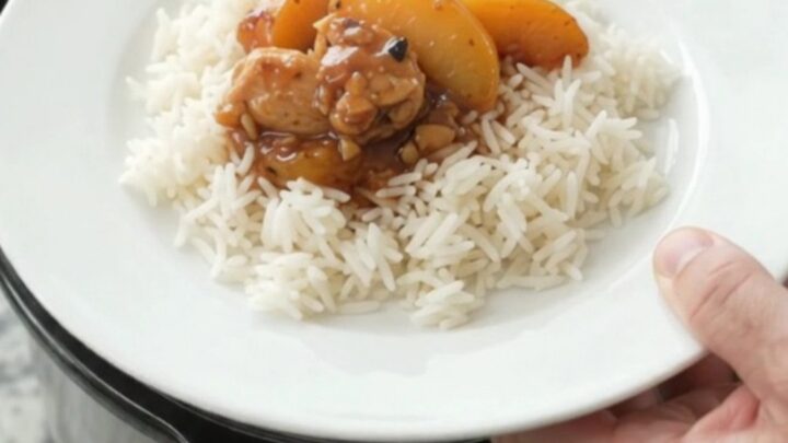 Slow cooker chicken and peaches in a glossy honey-soy sauce, served over rice